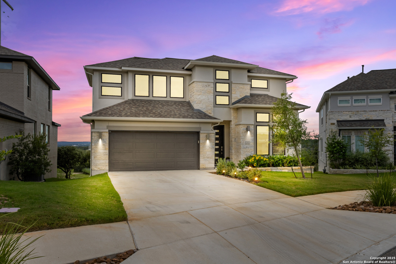 a front view of a house with a yard and garage