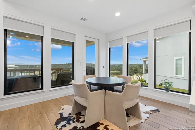 a dining room with furniture and wooden floor