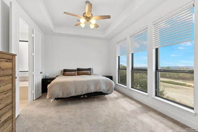 a bedroom with a bed and a large window