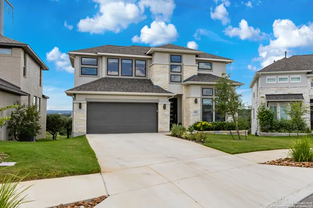 a front view of a house with a yard and garage