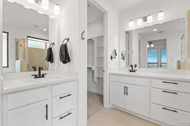 a bathroom with a double vanity sink mirror and