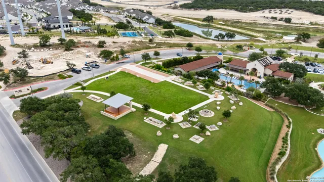 an aerial view of residential houses with outdoor space and street view