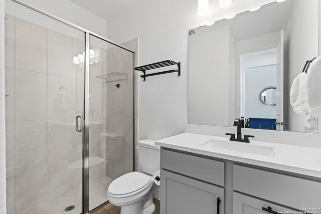 a bathroom with a sink toilet and shower