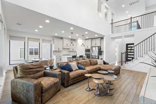 a living room with furniture or kitchen view and a wooden floor