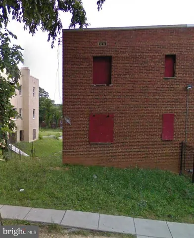 a brick building with a small yard