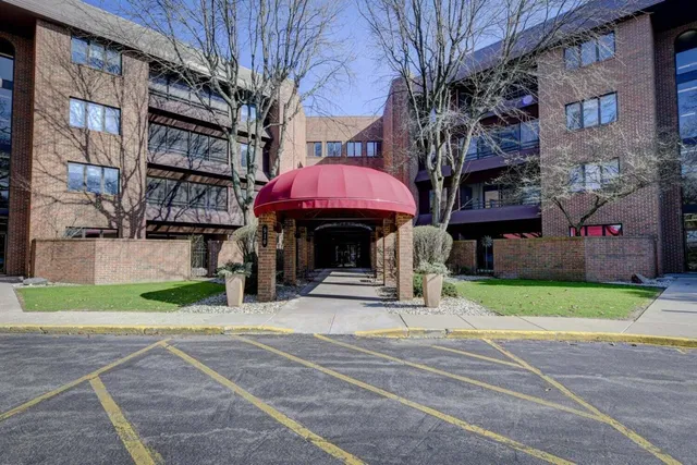 a man walking down a street next to a building
