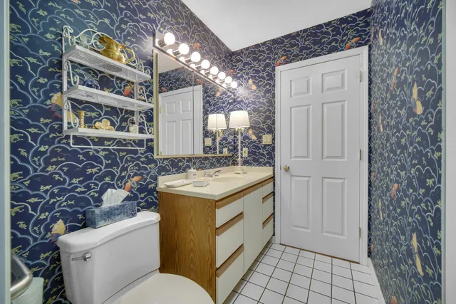 a bathroom with a sink a toilet and mirror