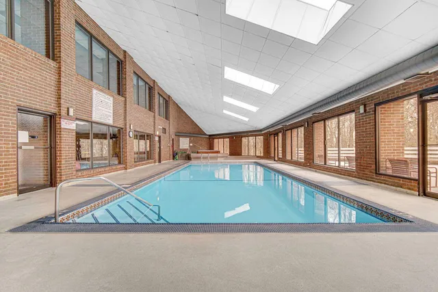a view of pool with brick walls