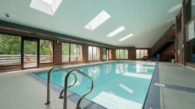 a floor to ceiling window with a table and chairs