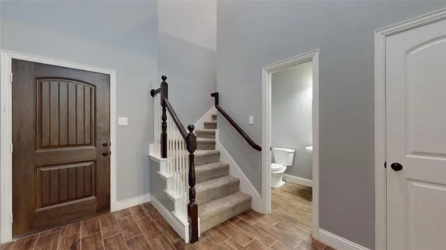 a view of entryway with wooden floor and stairs