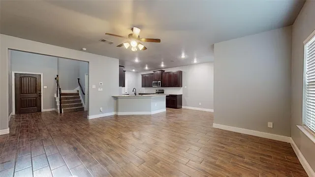 a view of kitchen with cabinets and wooden floor