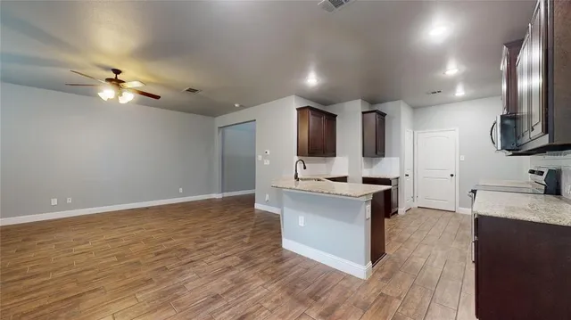 a kitchen with kitchen island a sink stainless steel appliances and cabinets