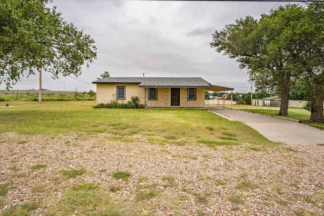 a view of a house with a swimming pool and a yard
