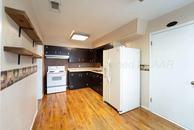 a kitchen with stainless steel appliances a refrigerator and a stove top oven