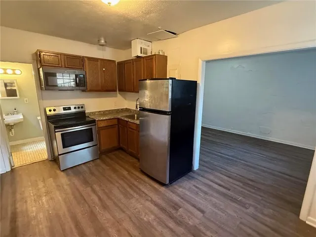 a kitchen with stainless steel appliances a refrigerator stove and microwave