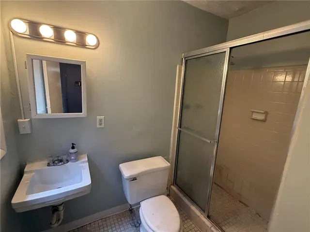 a bathroom with a toilet sink and shower