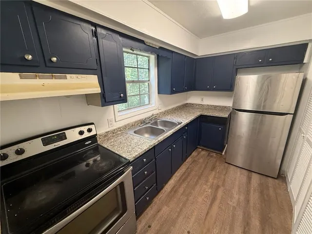 a kitchen with wooden cabinets and a stainless steel appliances