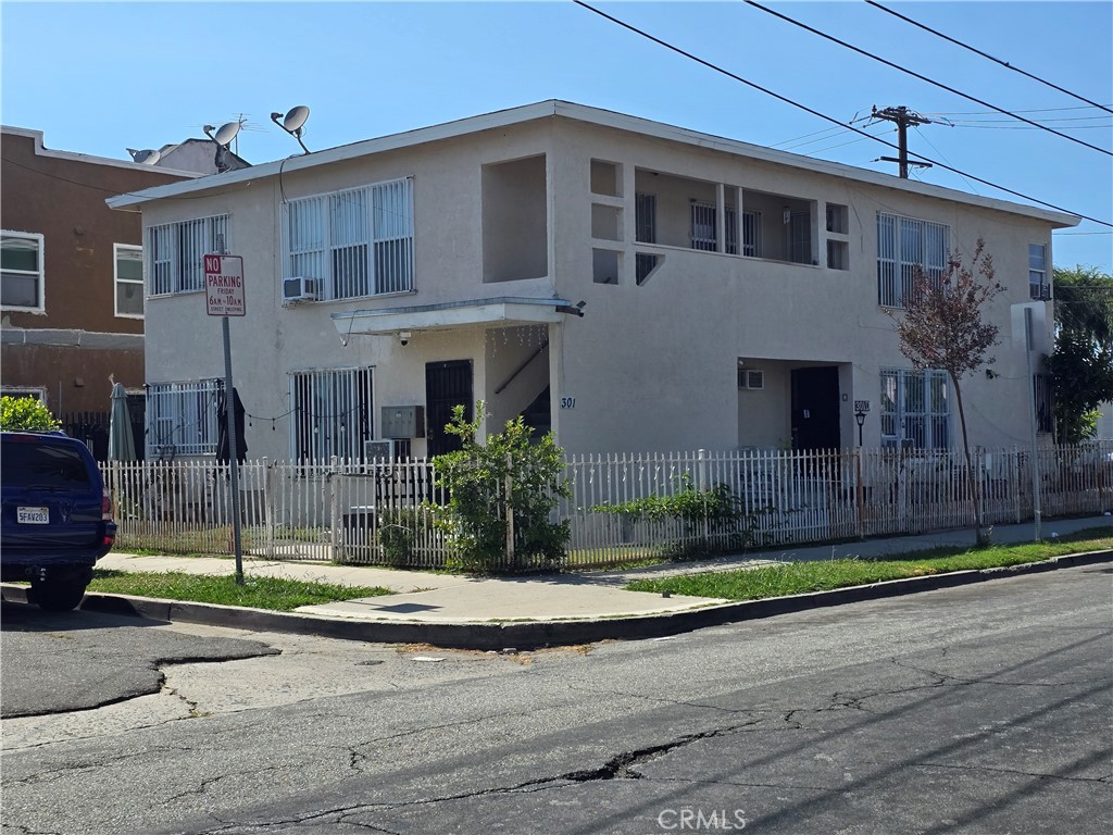 301 West Magnolia Street Compton, CA 90220 - Photo 1 of 6 a front view of a house with a yard and garage