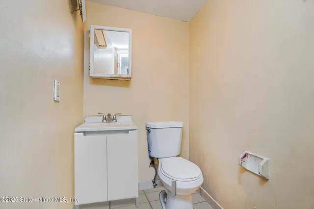 a white toilet sitting next to a bathroom sink