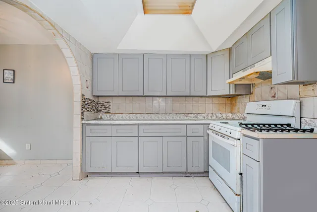 a kitchen with white cabinets