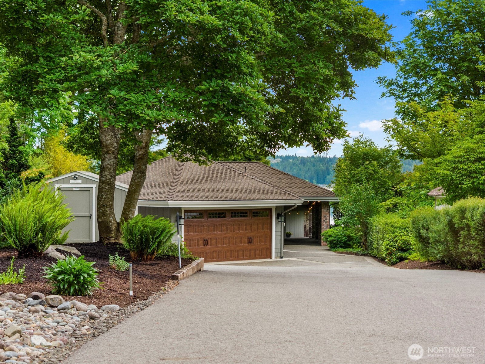 6591 Northeast North Shore Road Belfair, WA 98528 - Photo 6 of 37 a front view of a house with a garden