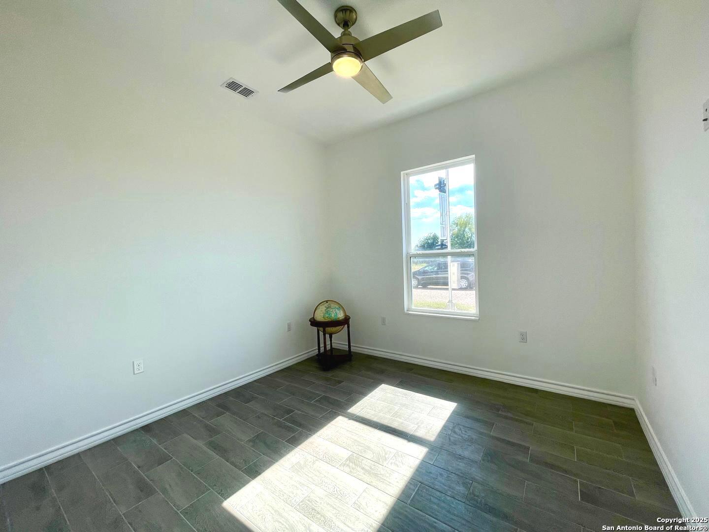 97 Berwick Road Victoria, TX 77904 - Photo 14 of 35 an empty room with a window and wooden floor