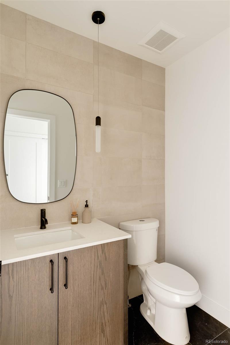2490 Wolff Street Denver, CO 80212 - Photo 19 of 41 a bathroom with a toilet sink and mirror