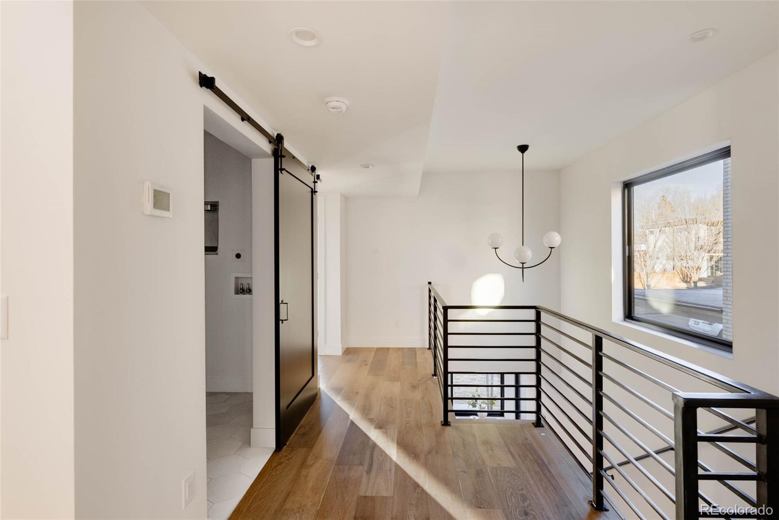 2490 Wolff Street Denver, CO 80212 - Photo 21 of 41 a view of a hallway with wooden floor and staircase