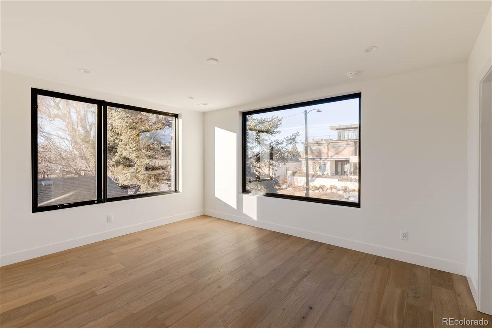 2490 Wolff Street Denver, CO 80212 - Photo 29 of 41 a view of a big room with wooden floor and doors