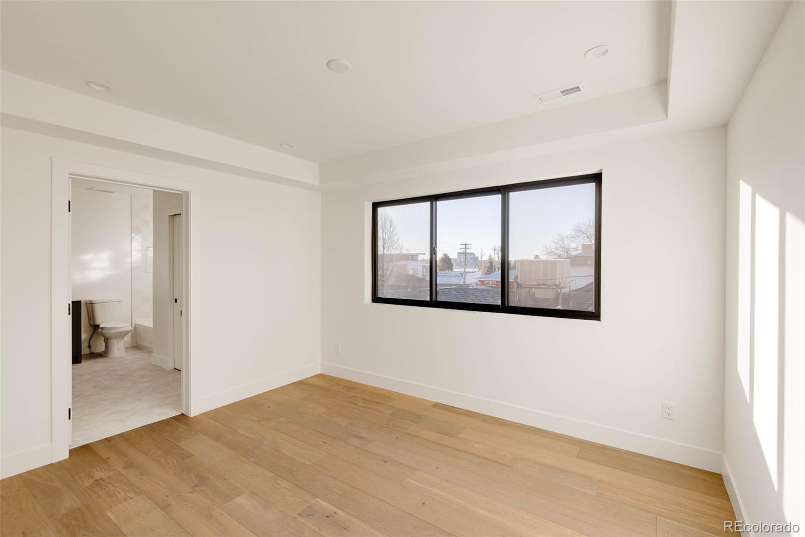2490 Wolff Street Denver, CO 80212 - Photo 30 of 41 a view of an empty room with wooden floor and a window