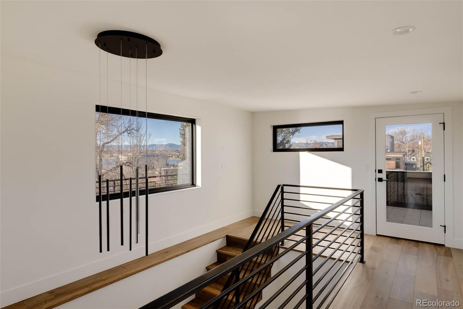 2490 Wolff Street Denver, CO 80212 - Photo 33 of 41 a view of a hallway with couches and wooden floor