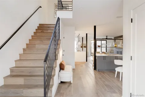 a living room with furniture a large window and a fireplace