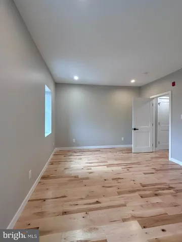 a bathroom with a glass door shower a sink and a mirror