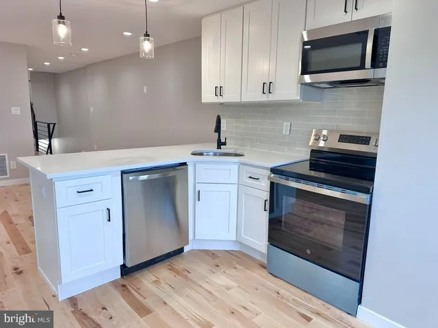 a kitchen with a stove and a sink