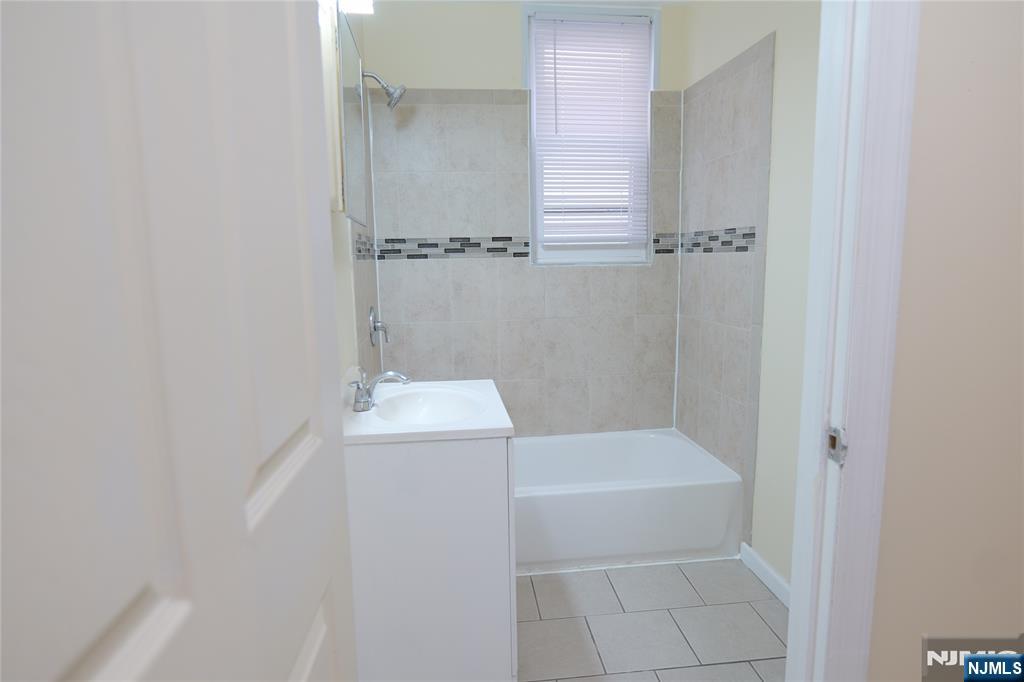 84 Scheerer Avenue Newark, NJ 07112 - Photo 8 of 9 a bathroom with a shower