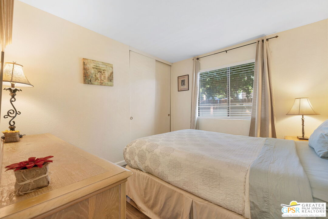 45688 Sutter Creek Road Indio, CA 92201 - Photo 29 of 51 a bedroom with a bed and a lamp