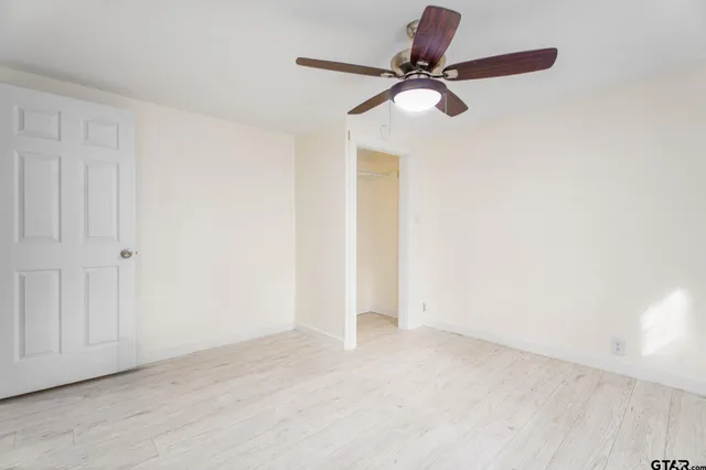 a view of a room with a ceiling fan