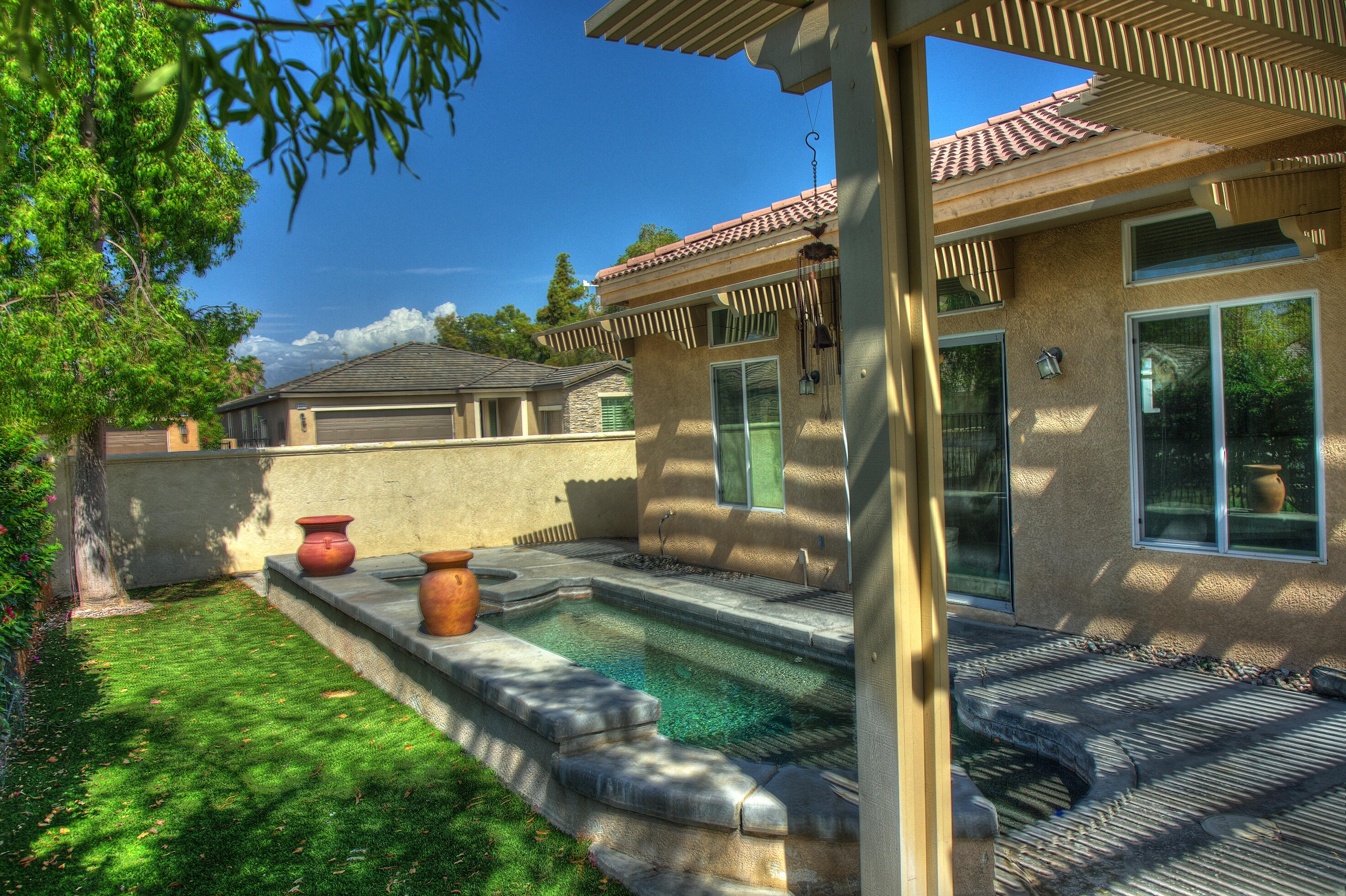 82531 Alda Drive Indio, CA 92201 - Photo 25 of 32 a front view of a house with outdoor seating and yard