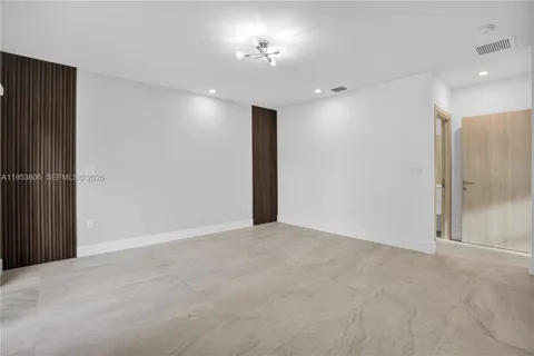 a view of an empty room with a mirror