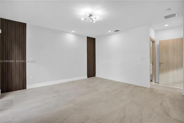 a view of an empty room with a mirror