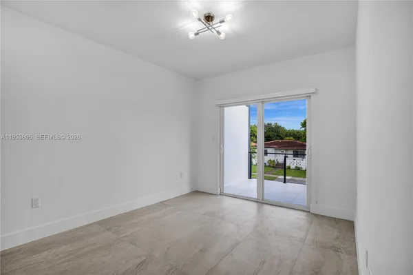 a view of an empty room with a window