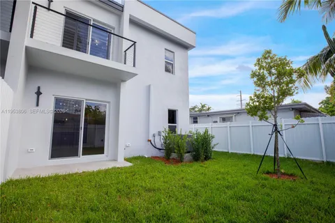 a view of a house with a yard and plants