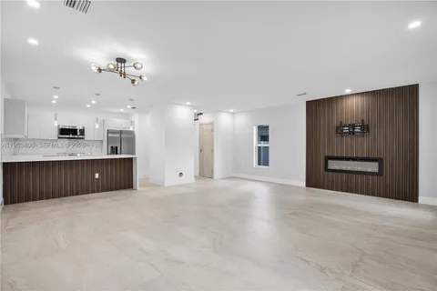 a view of a kitchen with a sink and a kitchen island