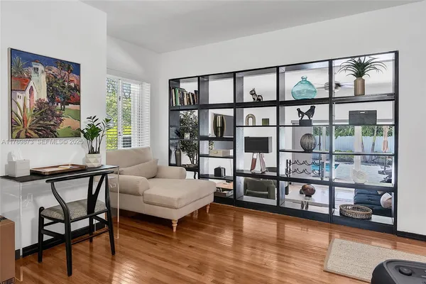 a kitchen with granite countertop white cabinets and a window