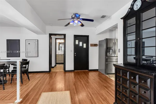 a view of a dining room with furniture and wooden floor