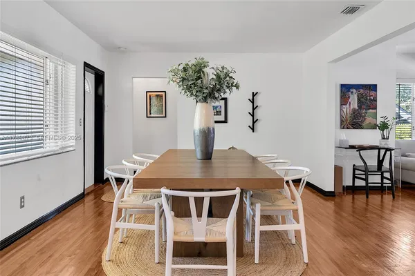 a view of a dining room with furniture and wooden floor