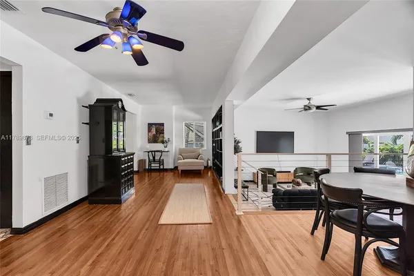 a bedroom with a bed a couch and a flat screen tv