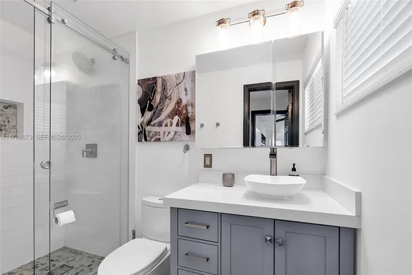 a bedroom with a bed a rug and a large window