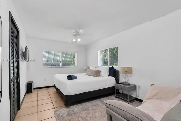 a bedroom with furniture and a window