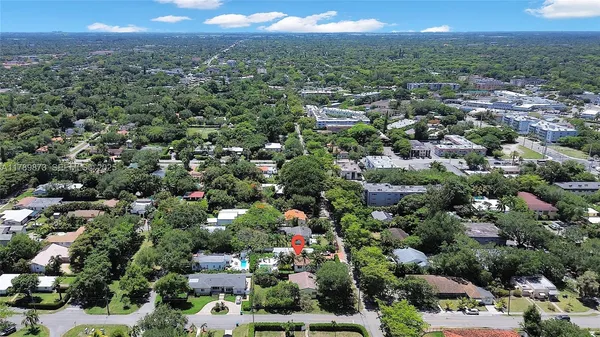 an aerial view of a houses with a yard and green space